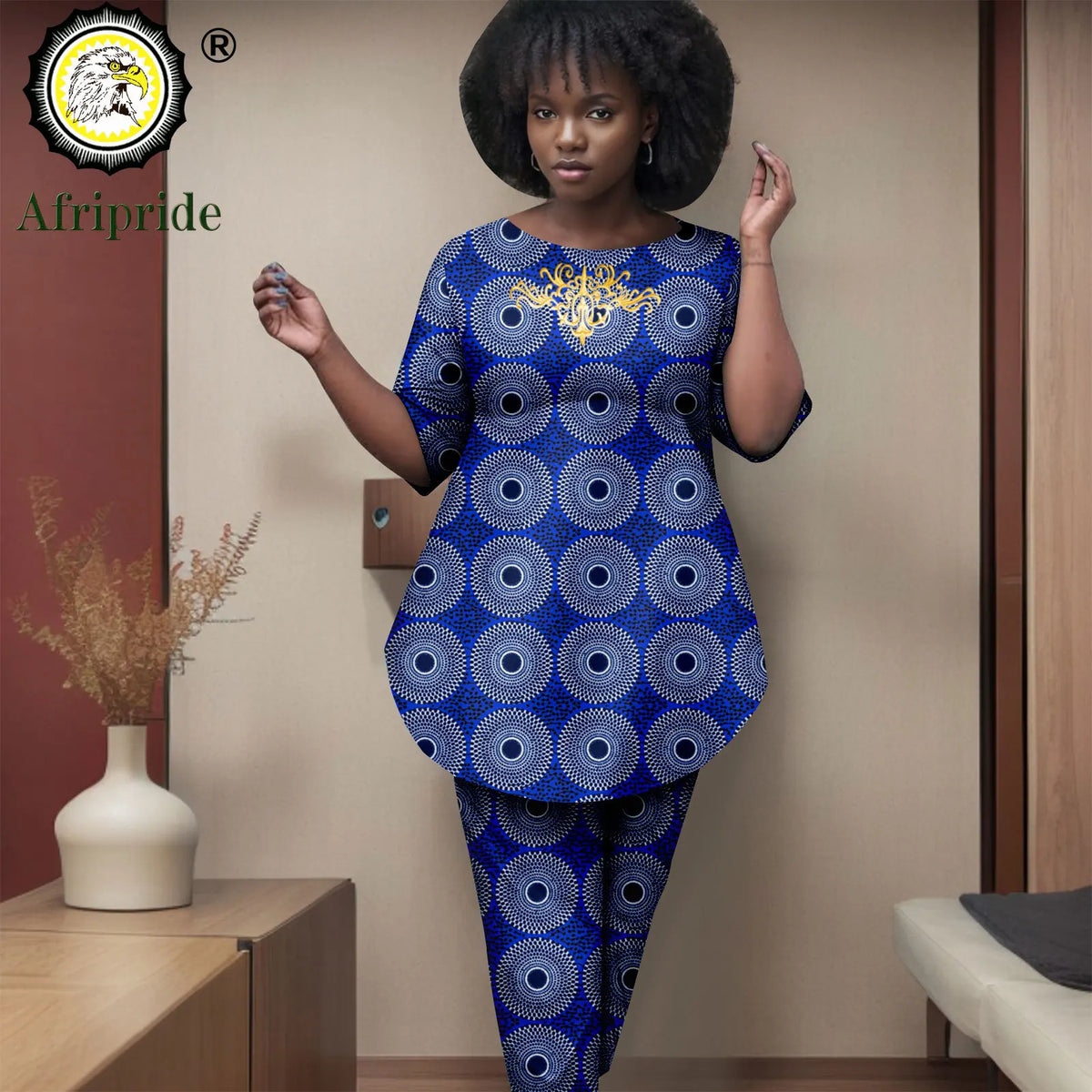 Woman wearing a blue and black patterned outfit with 'Afripride' branding.