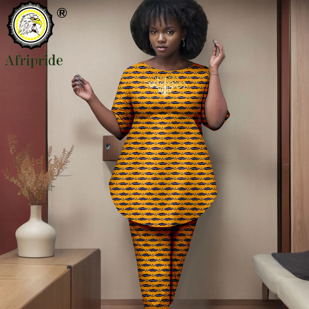 Woman wearing a yellow and black patterned outfit with 'Afripride' branding.